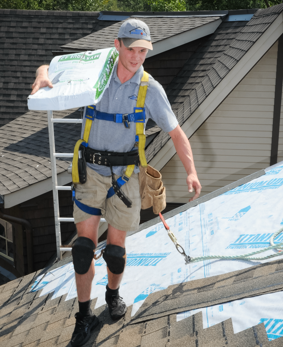 Eric, founder of The Public Bored, carrying shingles on a rooftop during his construction company days — the origin story behind the world's first crowdsourced billboard platform