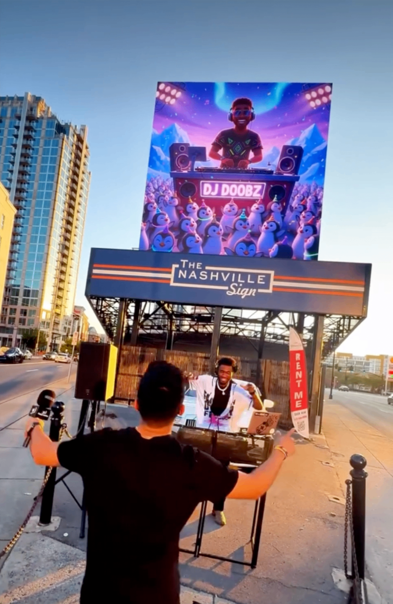 DJ performing live beneath The Nashville Sign billboard